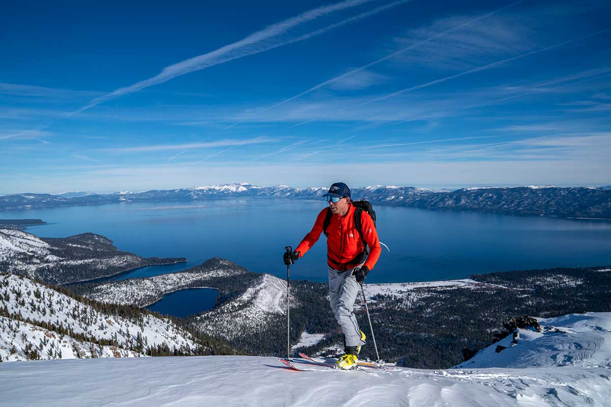 A cross-country skier on the trail, with the lake in the background.